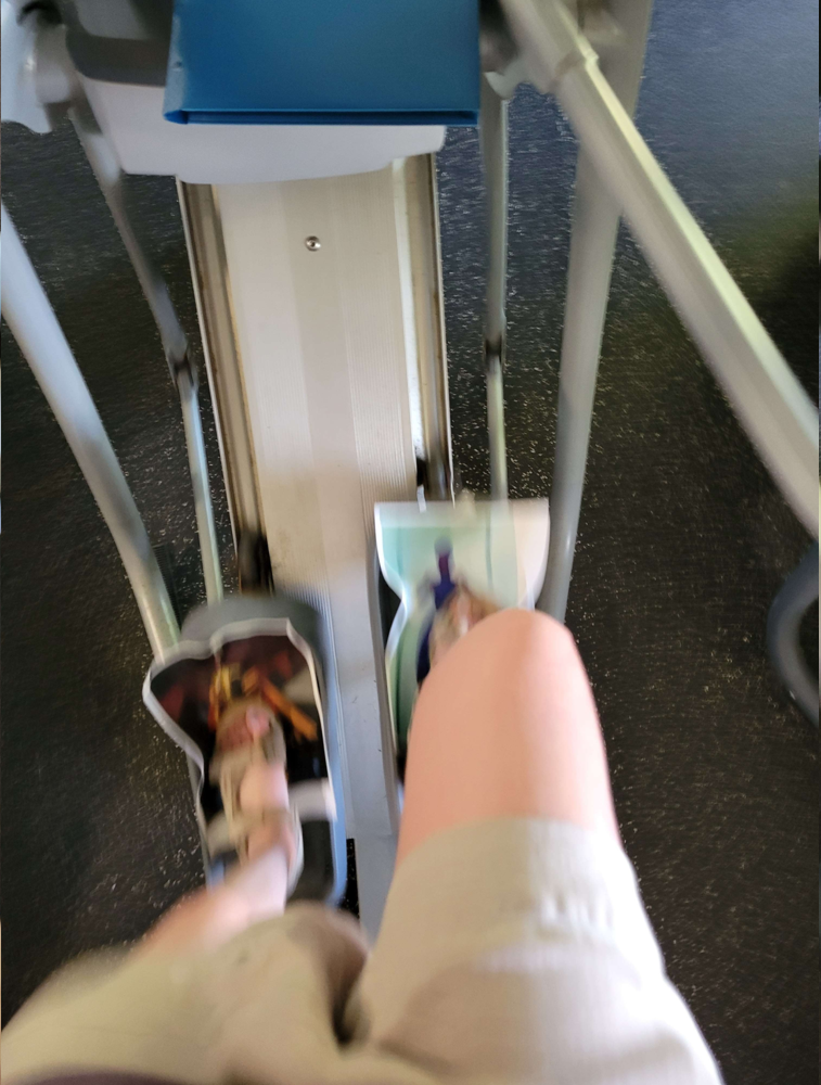 (image: Using the elliptical with AI upscaled heroes taped to the pedals. )